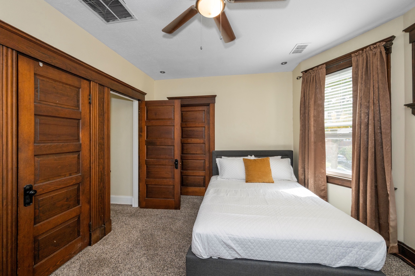 The 2nd of 2 queen bedrooms on the second level, with a dresser & ceiling fan