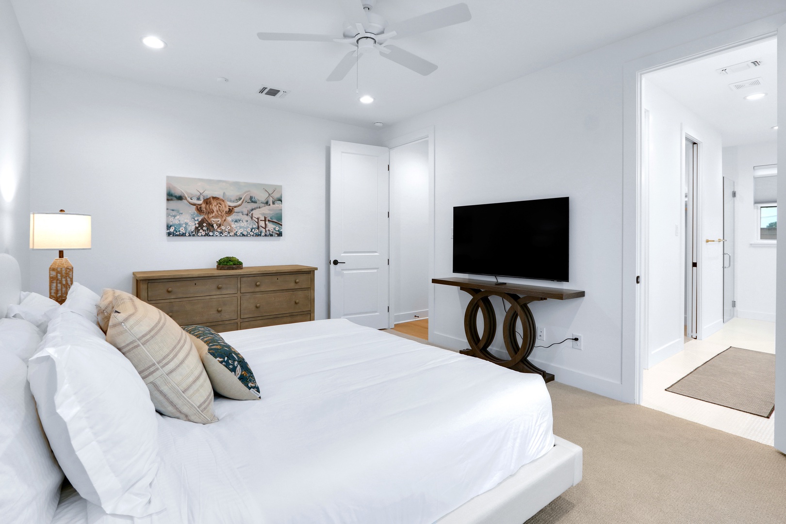 This 1st-floor king suite boasts a private ensuite, walk-in closet, & Smart TV
