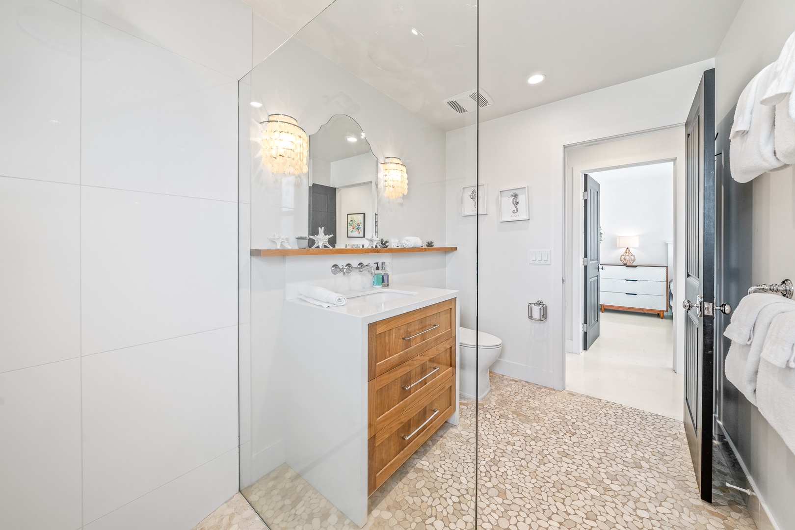 The full bathroom includes a chic single vanity & glass walk-in shower