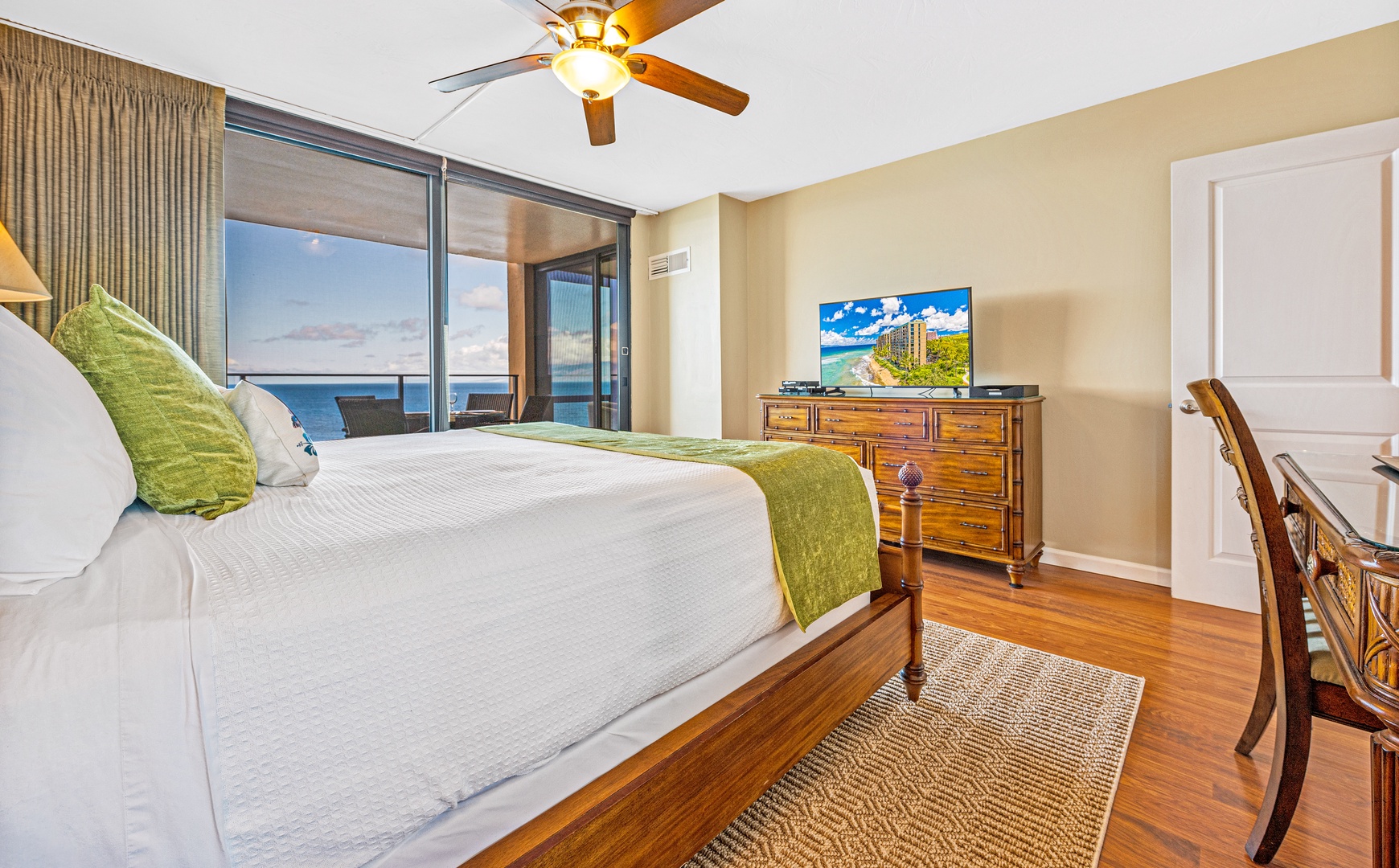 Bedroom with cal-king bed, lanai access, TV, and en-suite