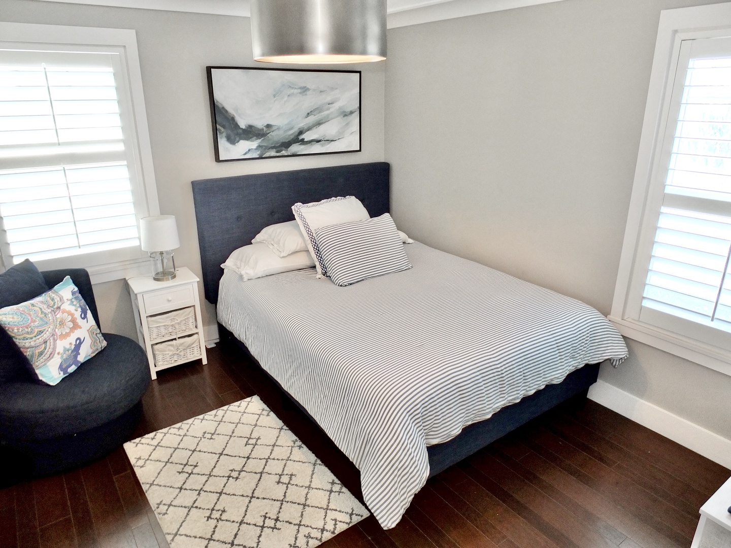 Relax in the second bedroom, containing a full bed and smart tv