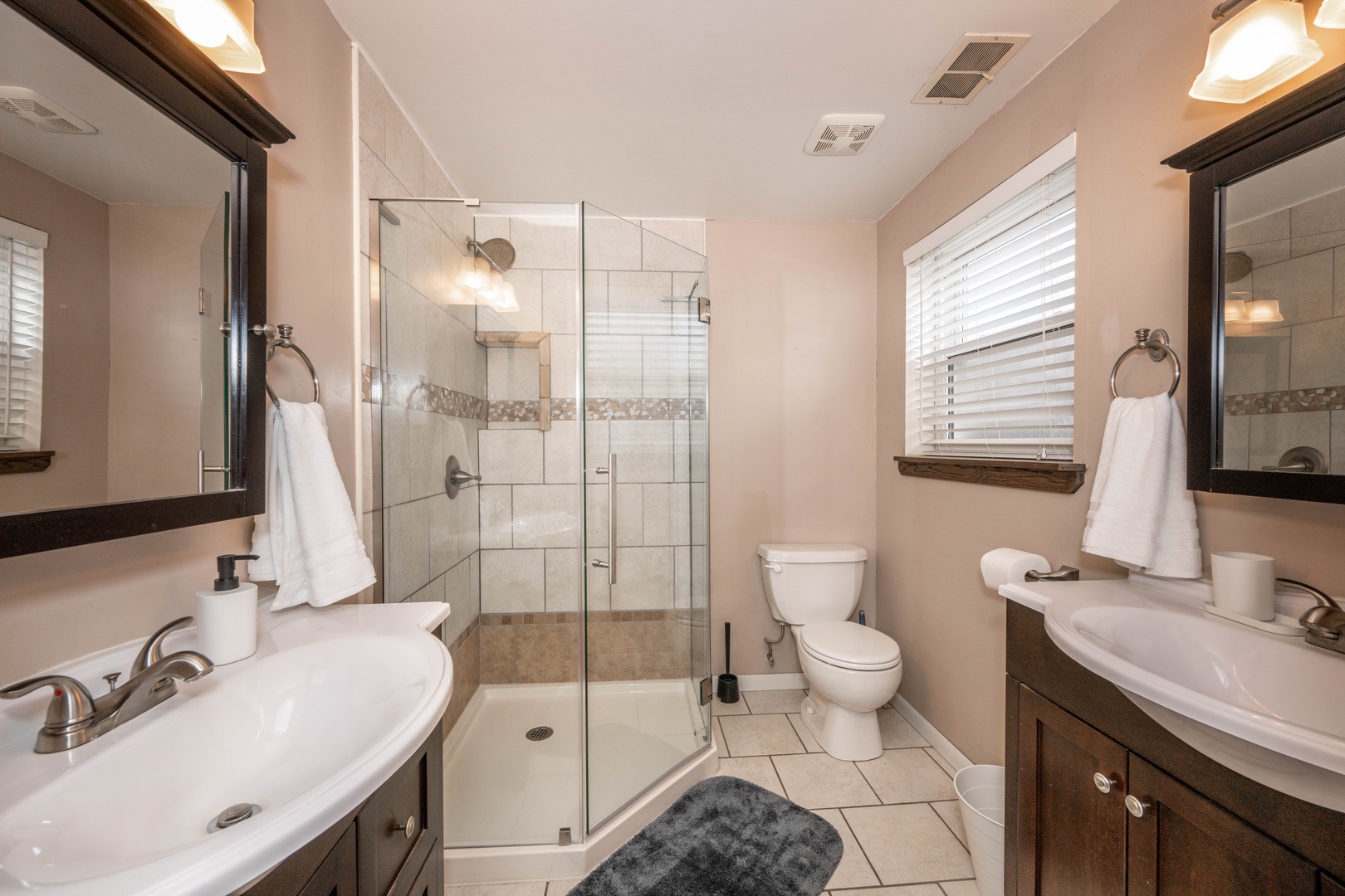 The master ensuite boasts dual vanities & a spa-like glass shower