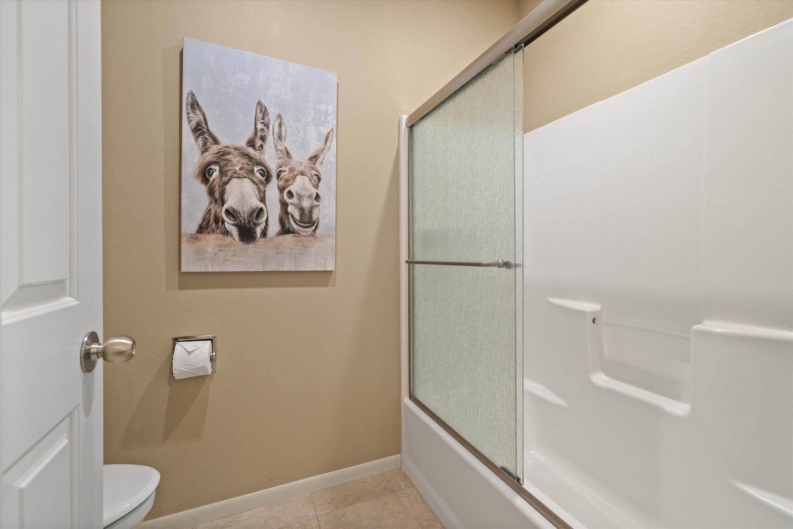 The full bathroom features an oversized single vanity & shower/tub combo