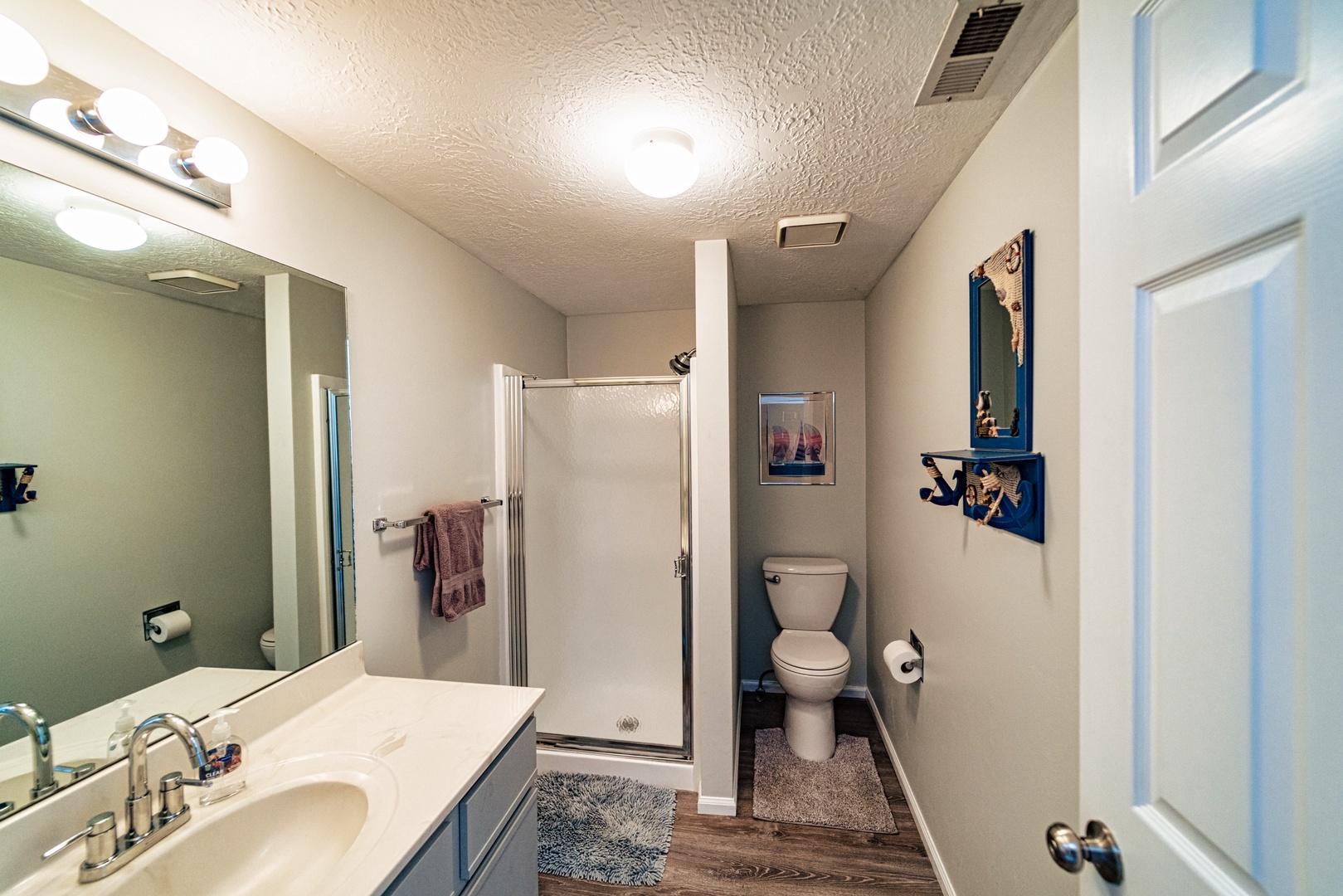 The second full bathroom offers a single vanity & glass shower