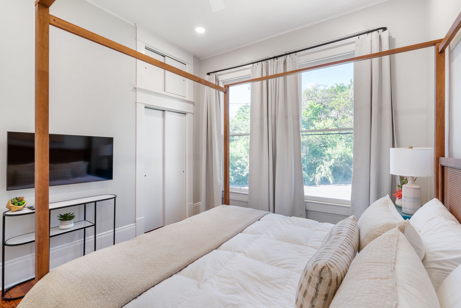 A regal king-sized bed & Smart TV await in the final bedroom retreat