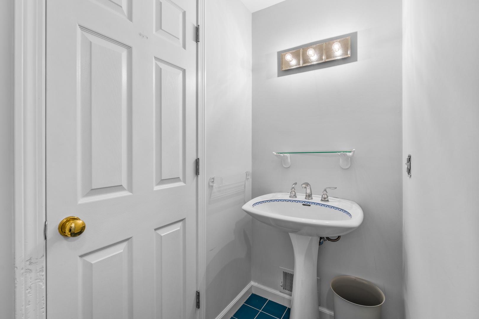 A pedestal sink & shower await in the ensuite bath