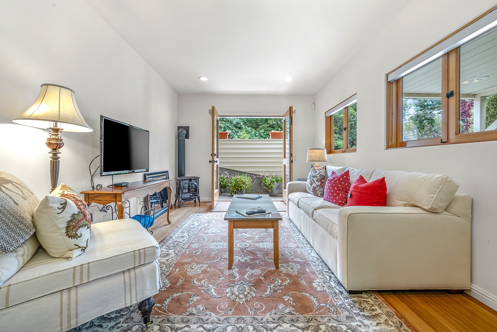 Bright living area with cozy seating and Smart TV