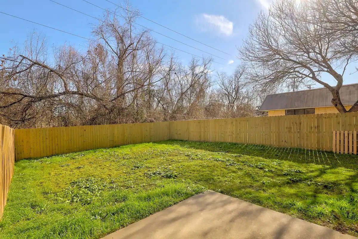 The fenced back yard offers loads of space for relaxation & play