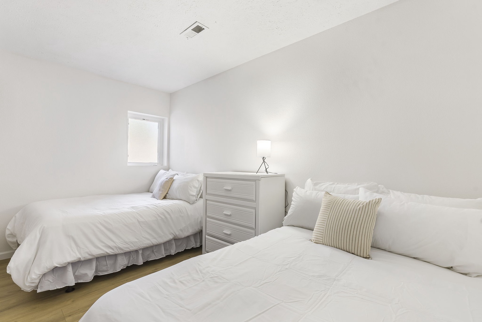 This 1st floor bedroom includes a pair of cozy full-sized beds