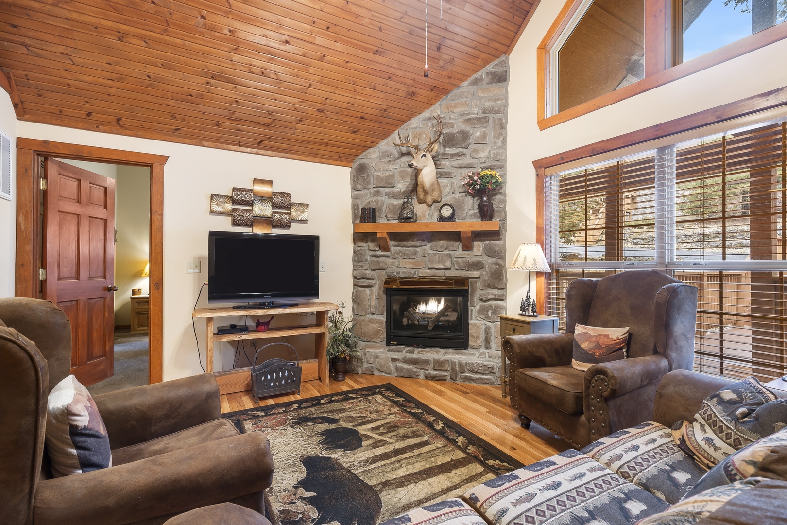 Living space with sofa sleeper, seasonal fireplace, and TV