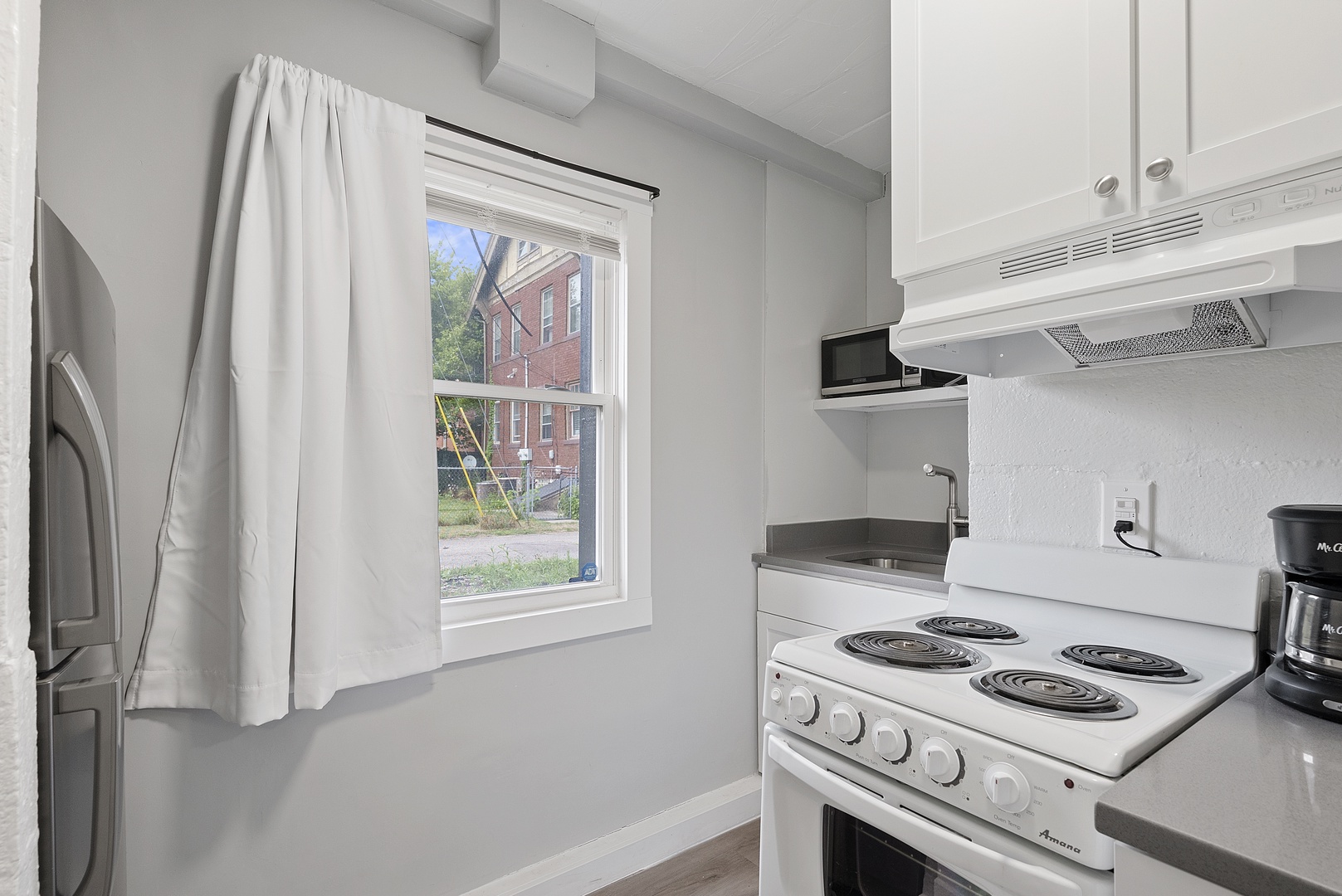 The cozy kitchen offers ample storage space & all the comforts of home