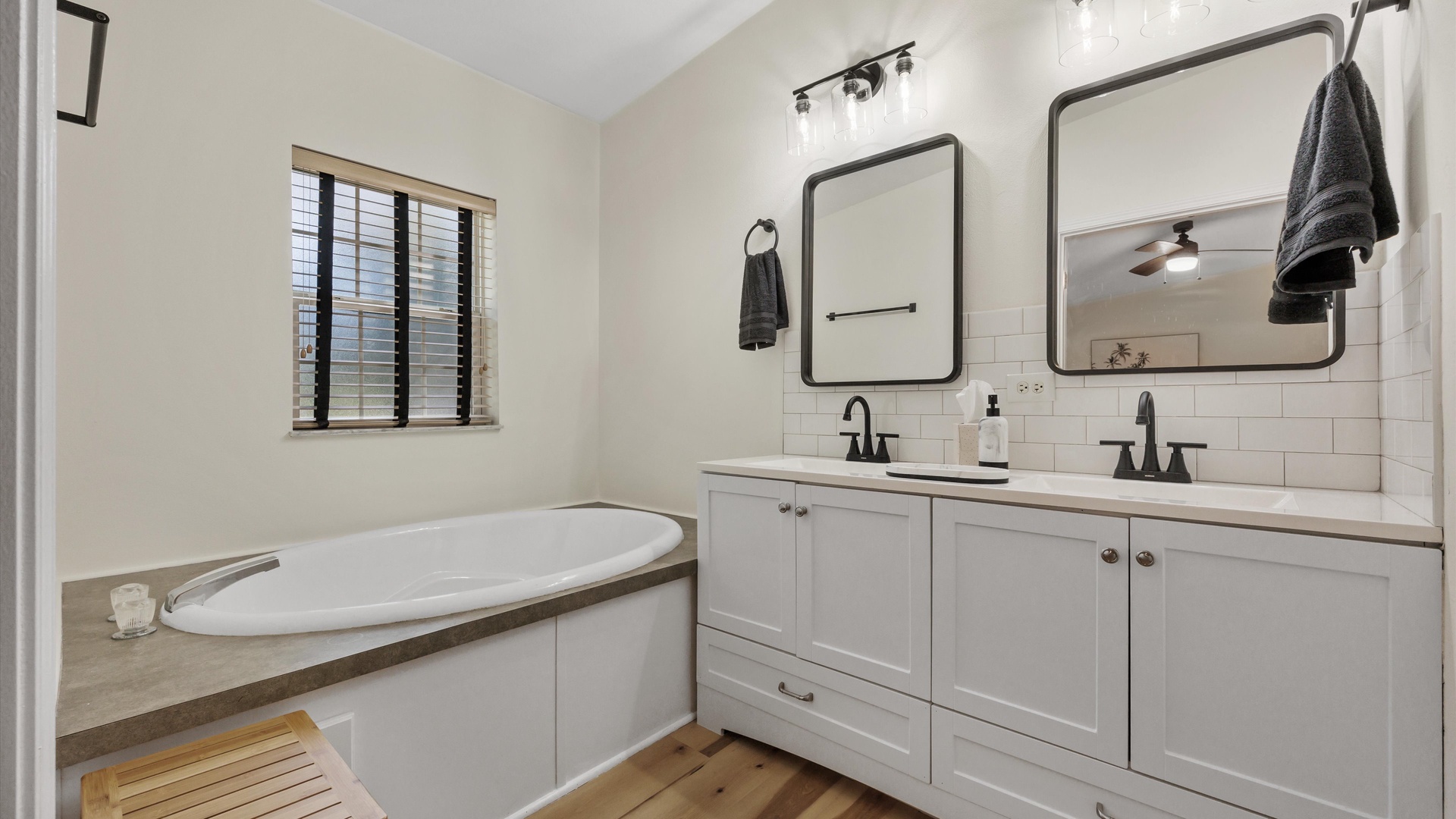 The master ensuite offers a double vanity, walk-in shower, & soaking tub