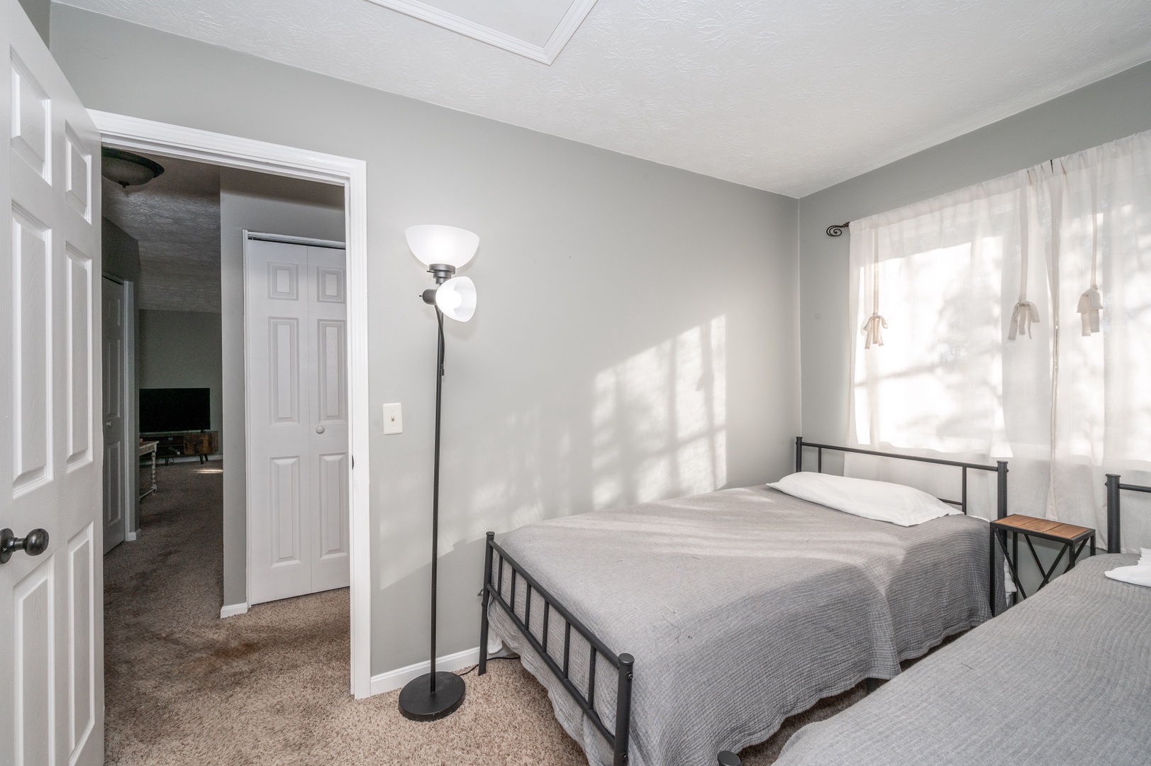 The second upper-level bedroom offers a pair of cozy twin beds