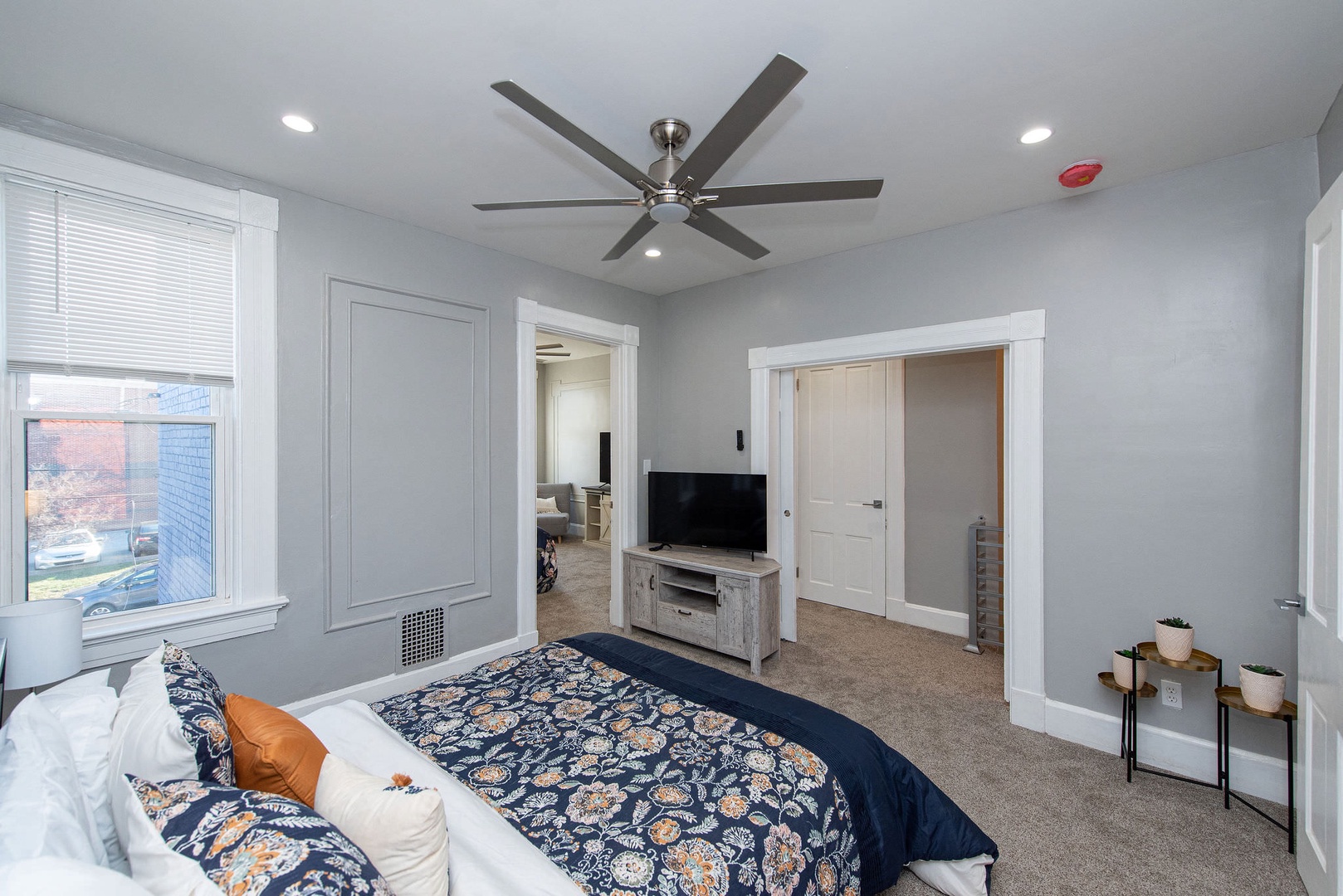 Suite 2 – The 2nd of 3 bedrooms includes a queen bed, Smart TV, & ceiling fan