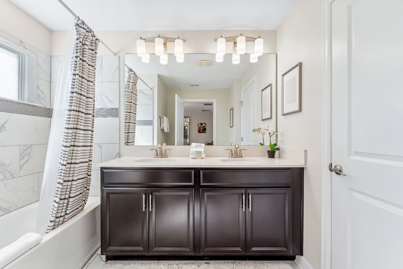 A double vanity, shower, & tub await in the ensuite bath