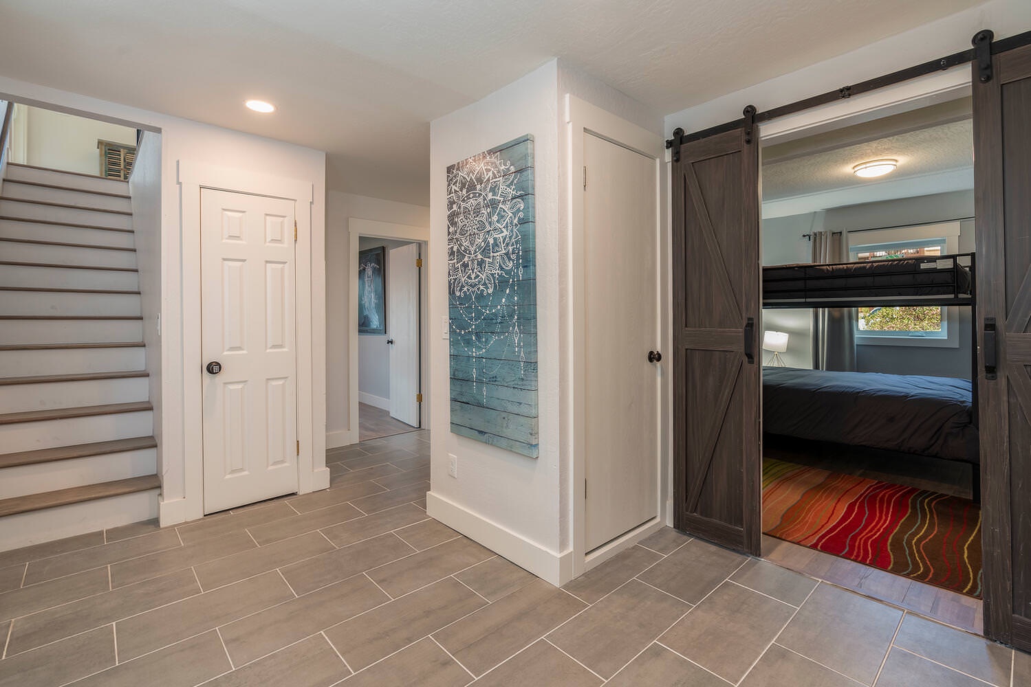 Home's entryway leads to downstairs bedroom space