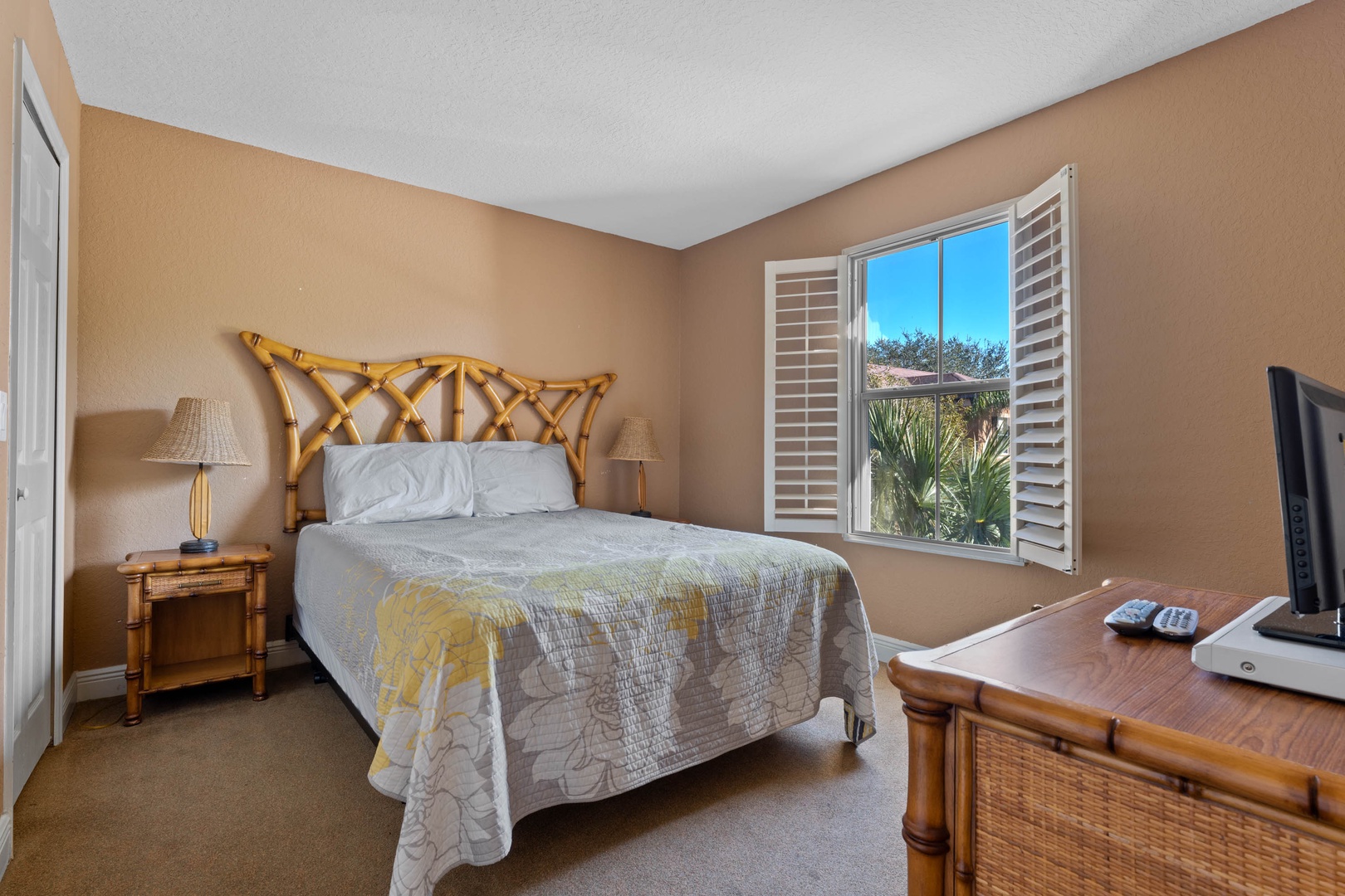 This 2nd floor queen bedroom includes a TV & tranquil views