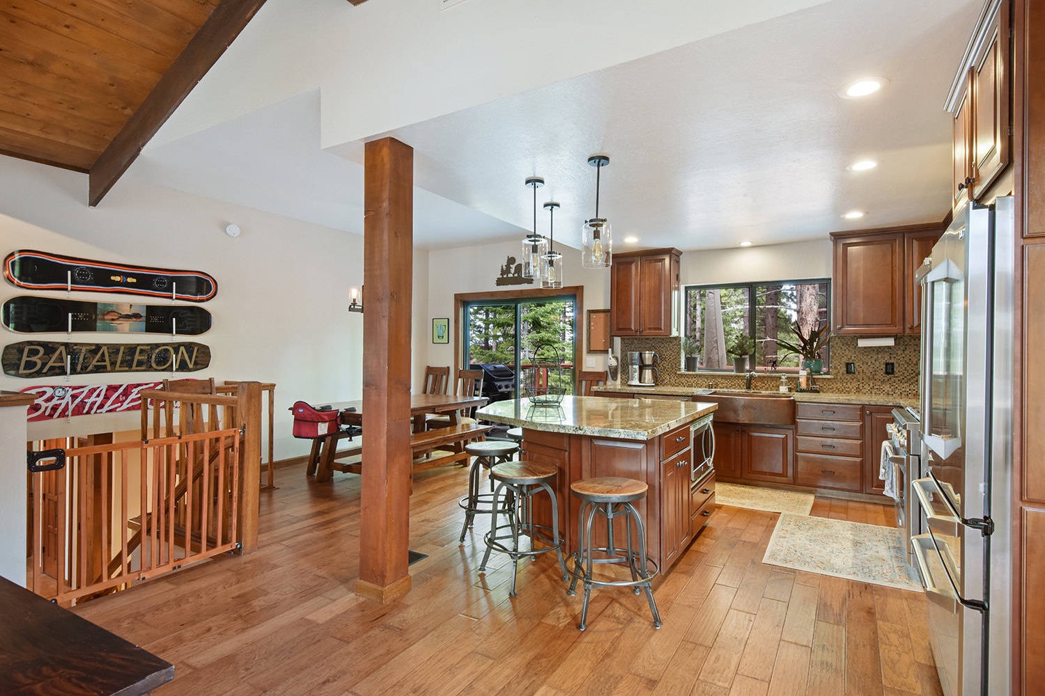 Large open dining and kitchen space with back deck access