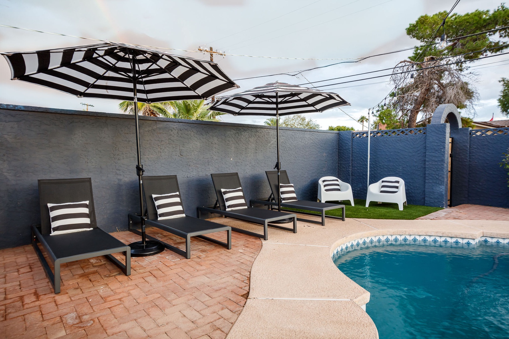 Resort-style lounge chairs around the private heated pool