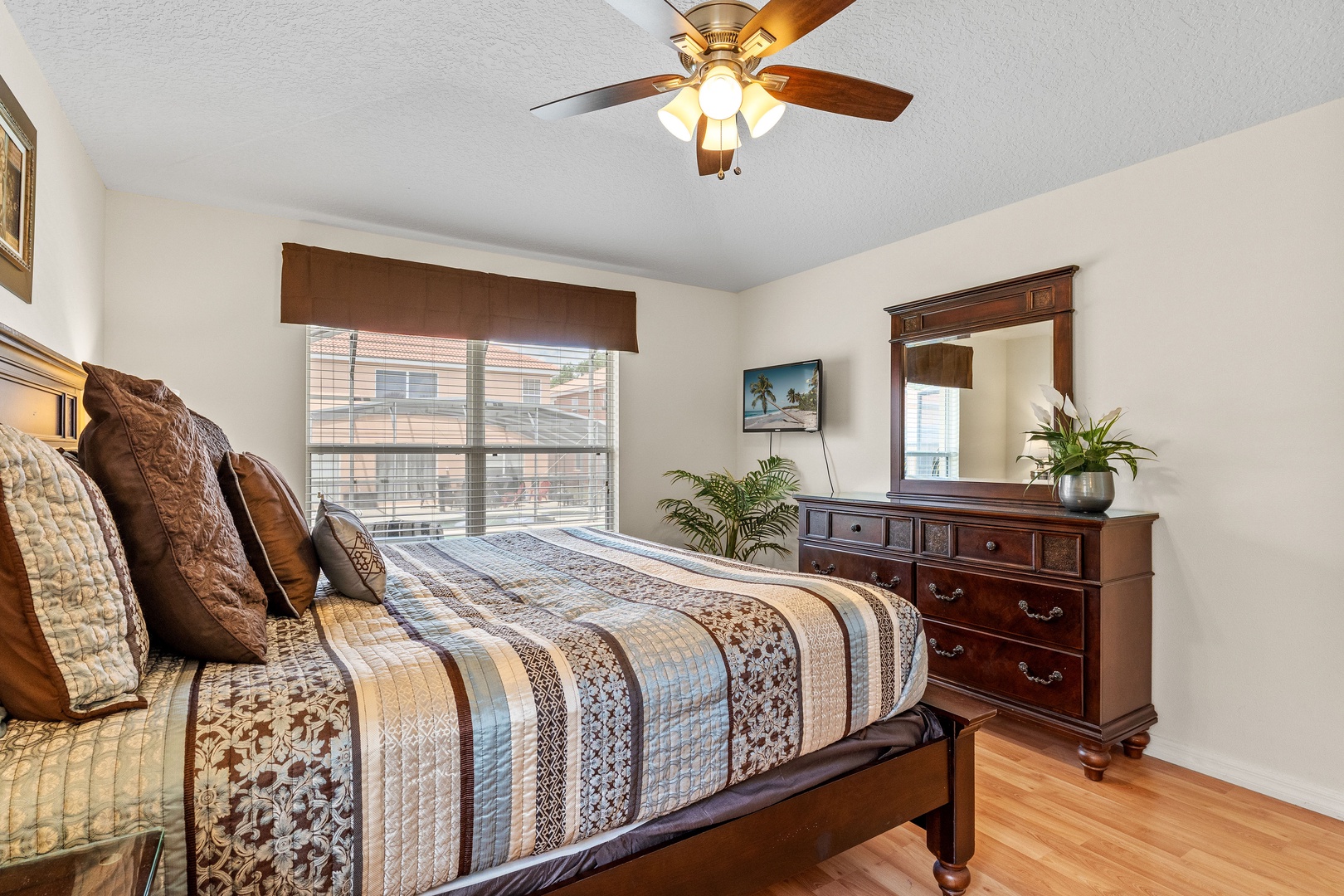 Cozy bedroom with queen bed, Smart TV, ceiling fan and ensuite