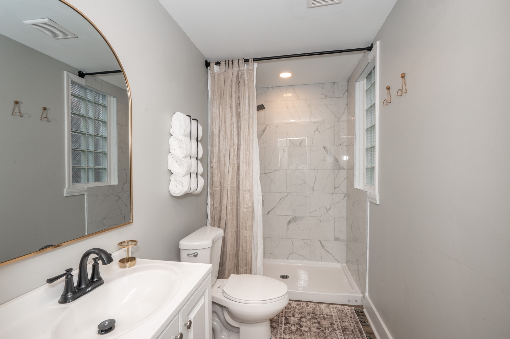 The full bathroom offers a walk-in shower & chic finishes