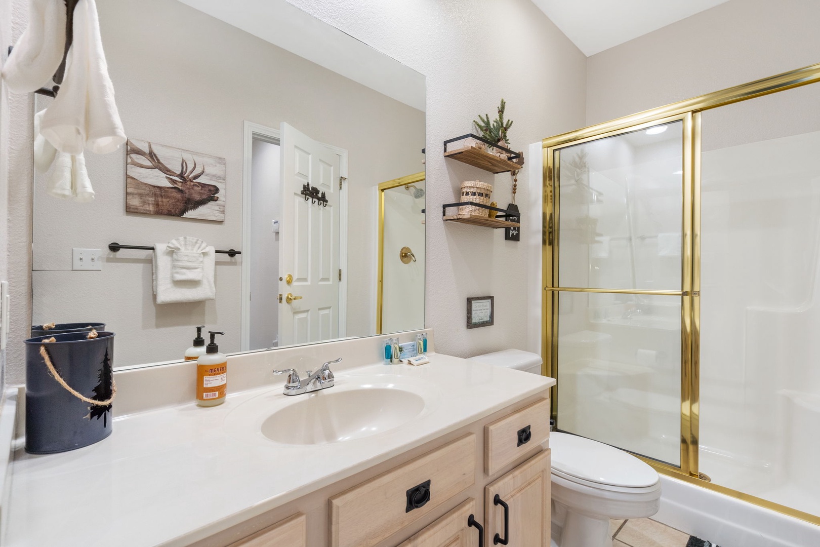 This full bathroom with a shower connects the queen bedroom to the hall