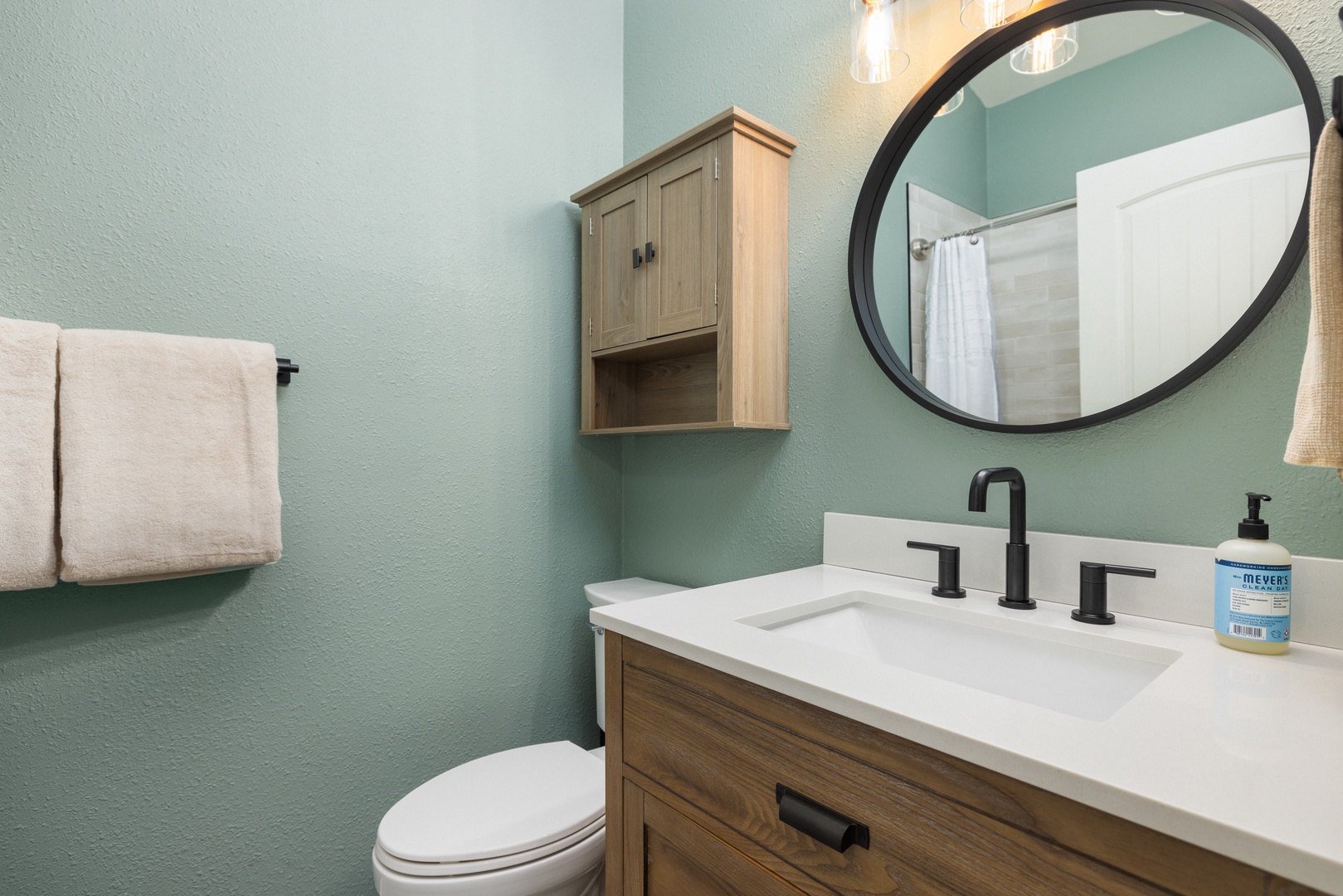 The full bathroom showcases a modern single vanity & shower/tub combo