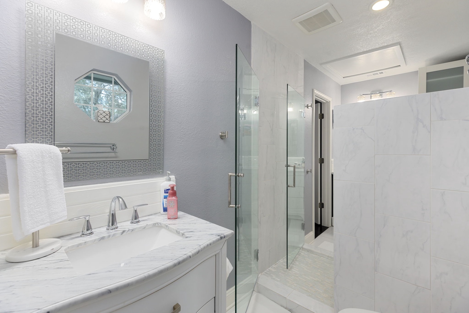 Private dual vanity areas & a glass walk-in shower await in this Jack & Jill bath