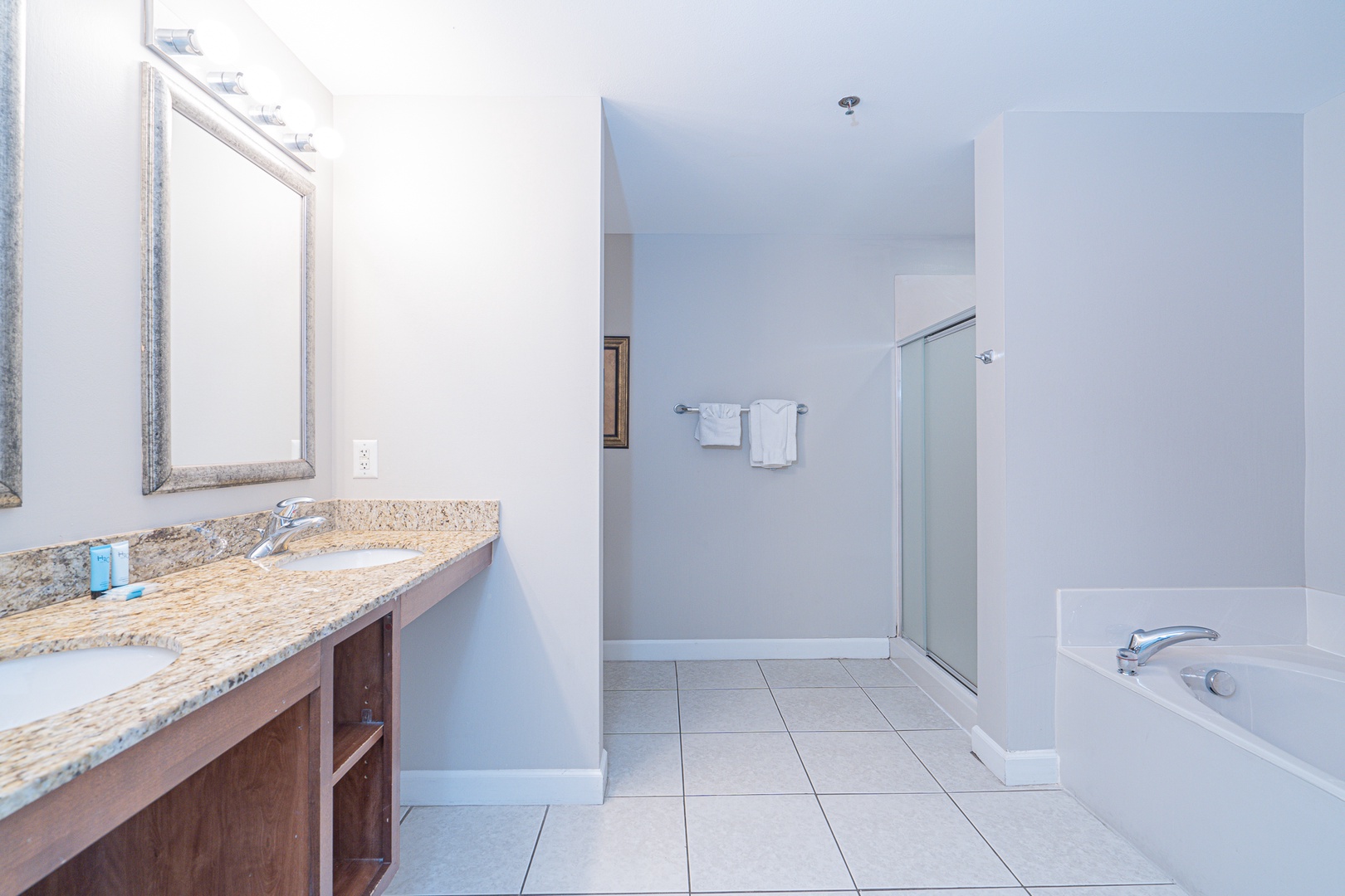 The master ensuite offers a double vanity, glass shower, & soaking tub