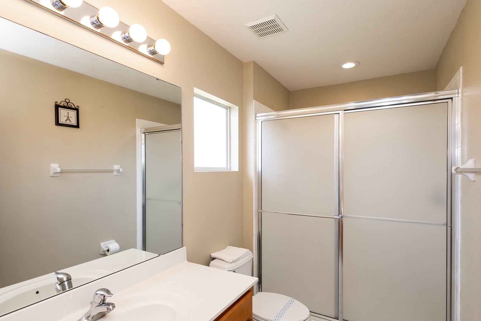 This queen en suite bathroom includes a single vanity & glass shower