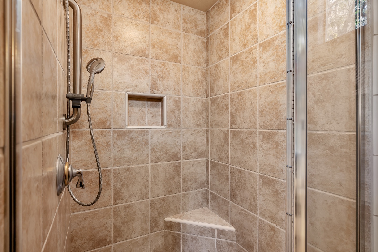 The king en suite boasts a double vanity, walk-in shower, & jetted soaking tub