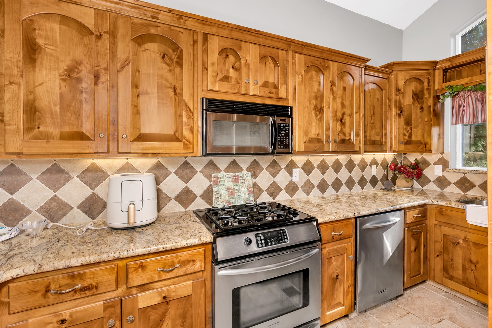 The gorgeous kitchen offers ample space & all the comforts of home