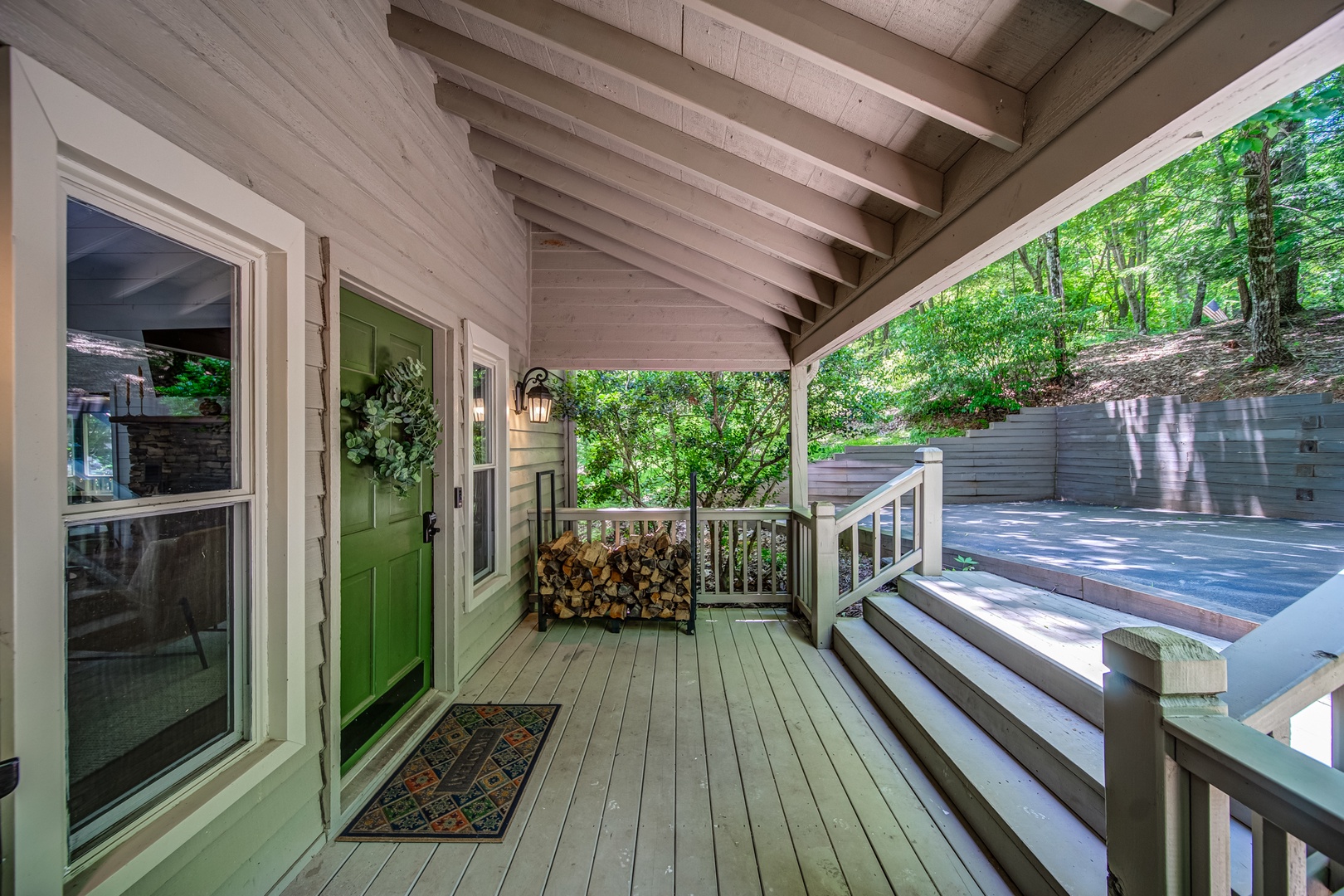 Find comfortable entry and plenty of firewood on the sprawling front porch