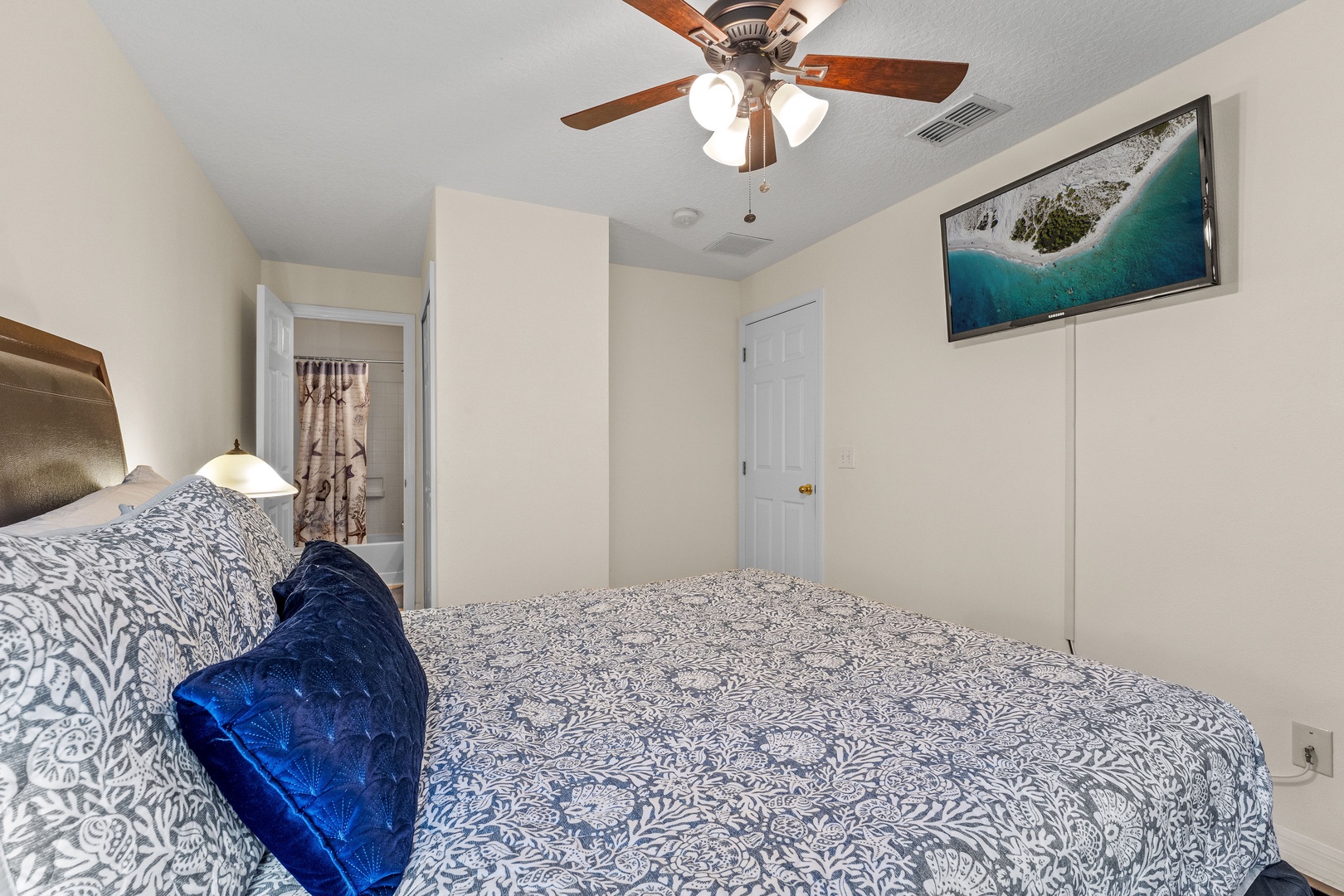 Cozy king bedroom with ceiling fan and private ensuite