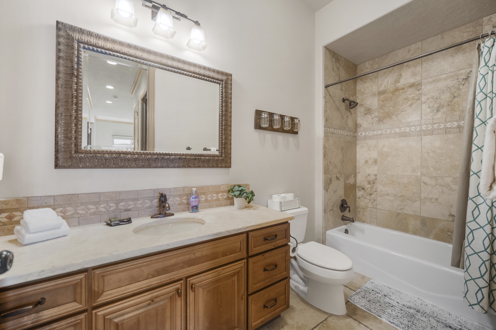 The hall bath features a large single vanity & shower/tub combo