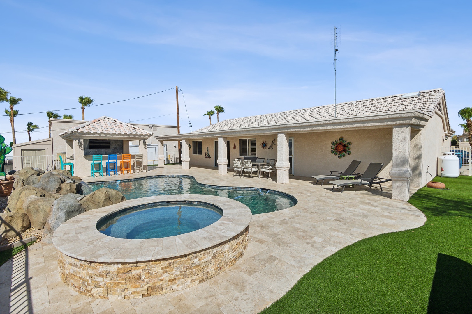 A mountain-view oasis, with a waterfall pool, hot tub, & outdoor kitchen!