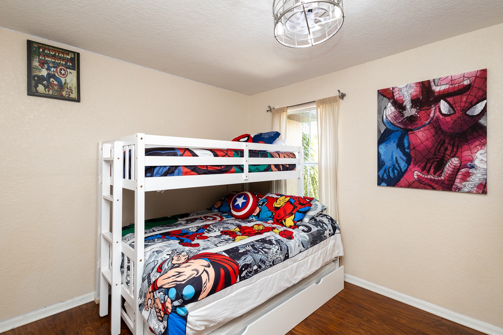 Superheroes can slumber on this bedroom’s twin/queen bunks & twin trundle