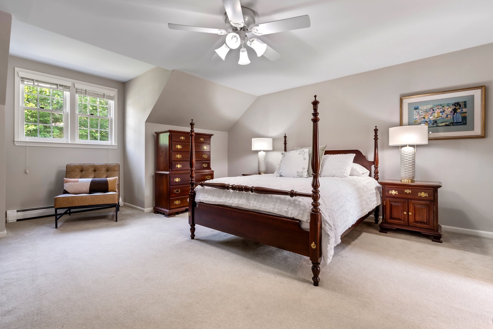 This cozy queen suite features a ceiling fan and private ensuite