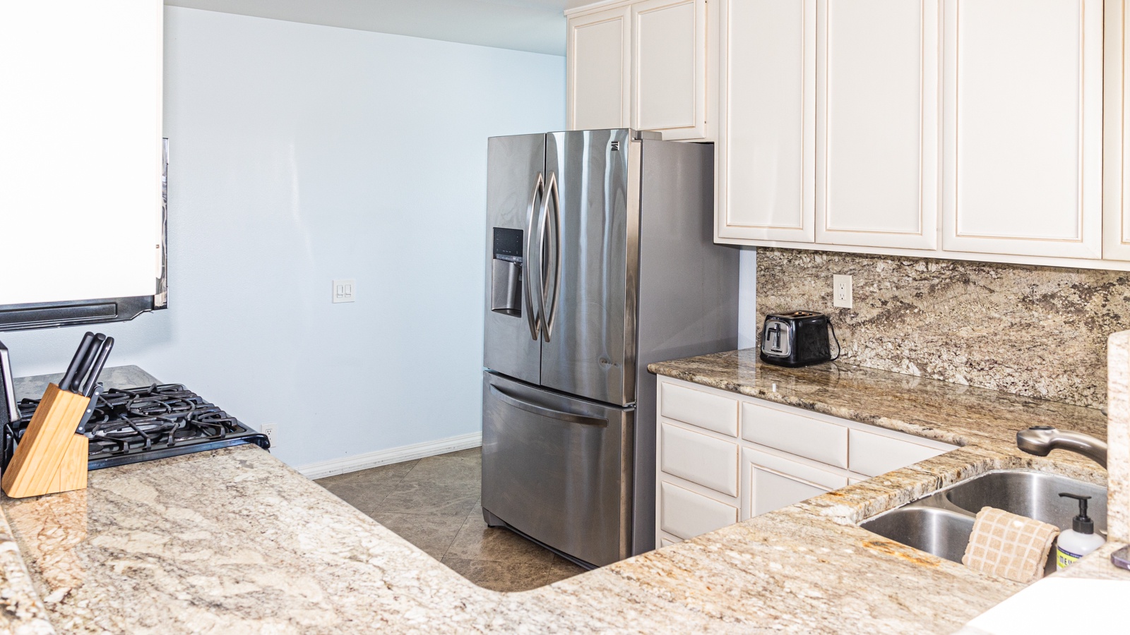 The open, airy kitchen offers ample space & every home comfort