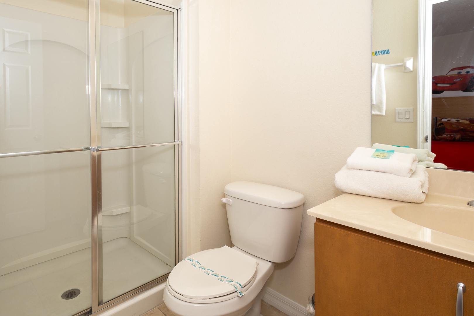 The twin room en suite offers a spacious single vanity & glass shower