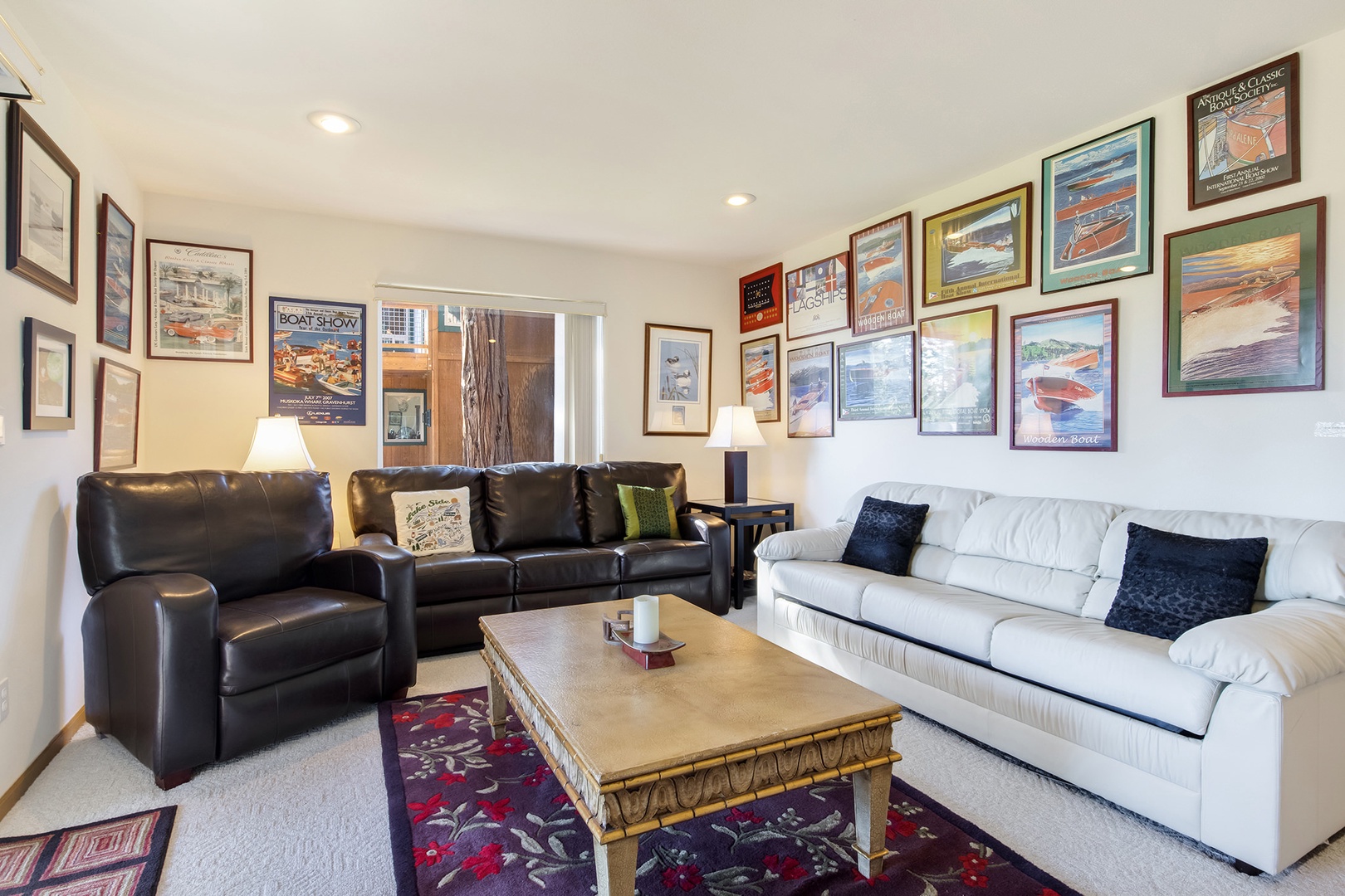 Additional living area on the bottom floor with balcony, seating, and TV