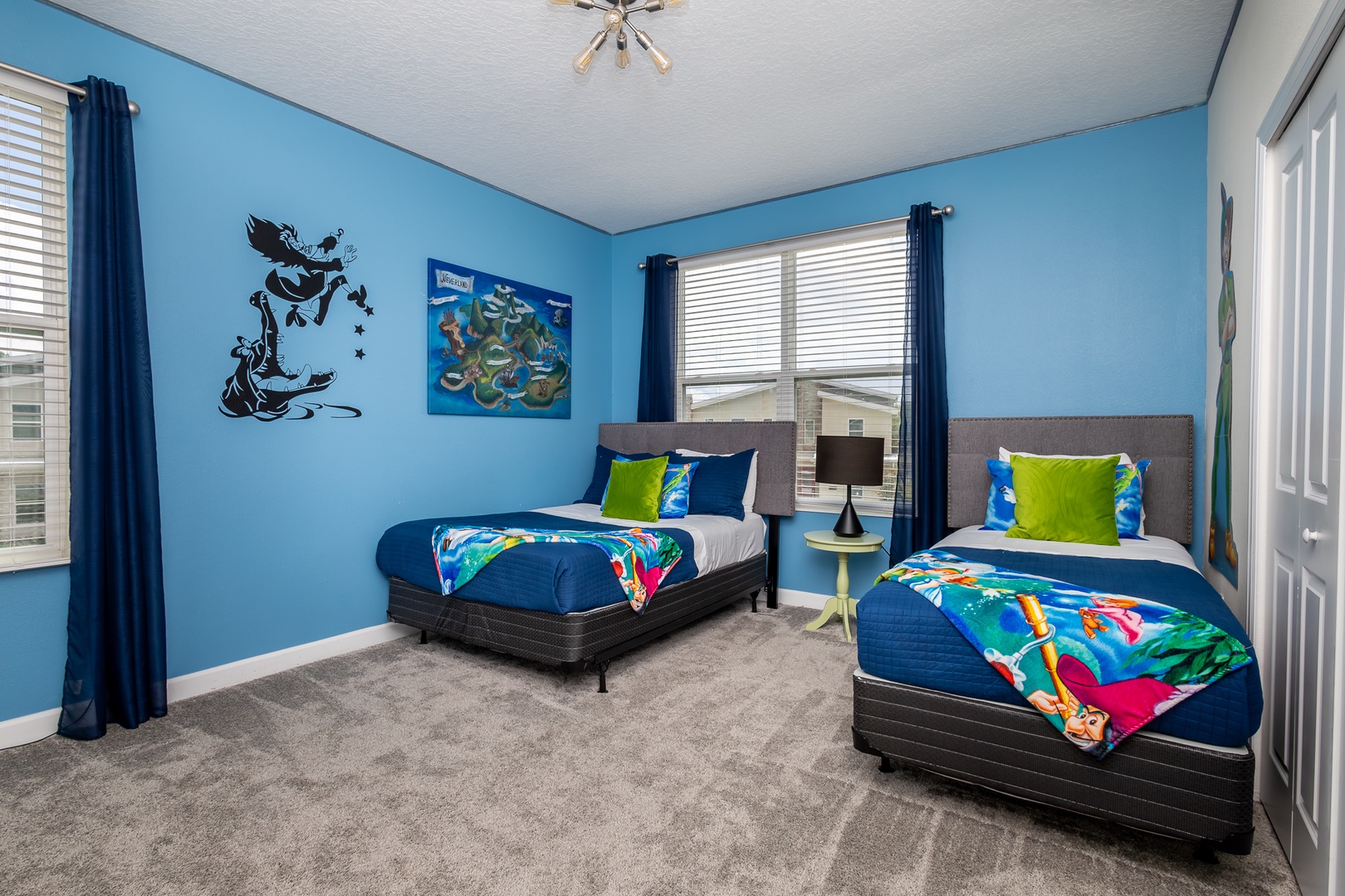 This bedroom’s twin bed, full bed, & smart TV will have you believing in fairies!