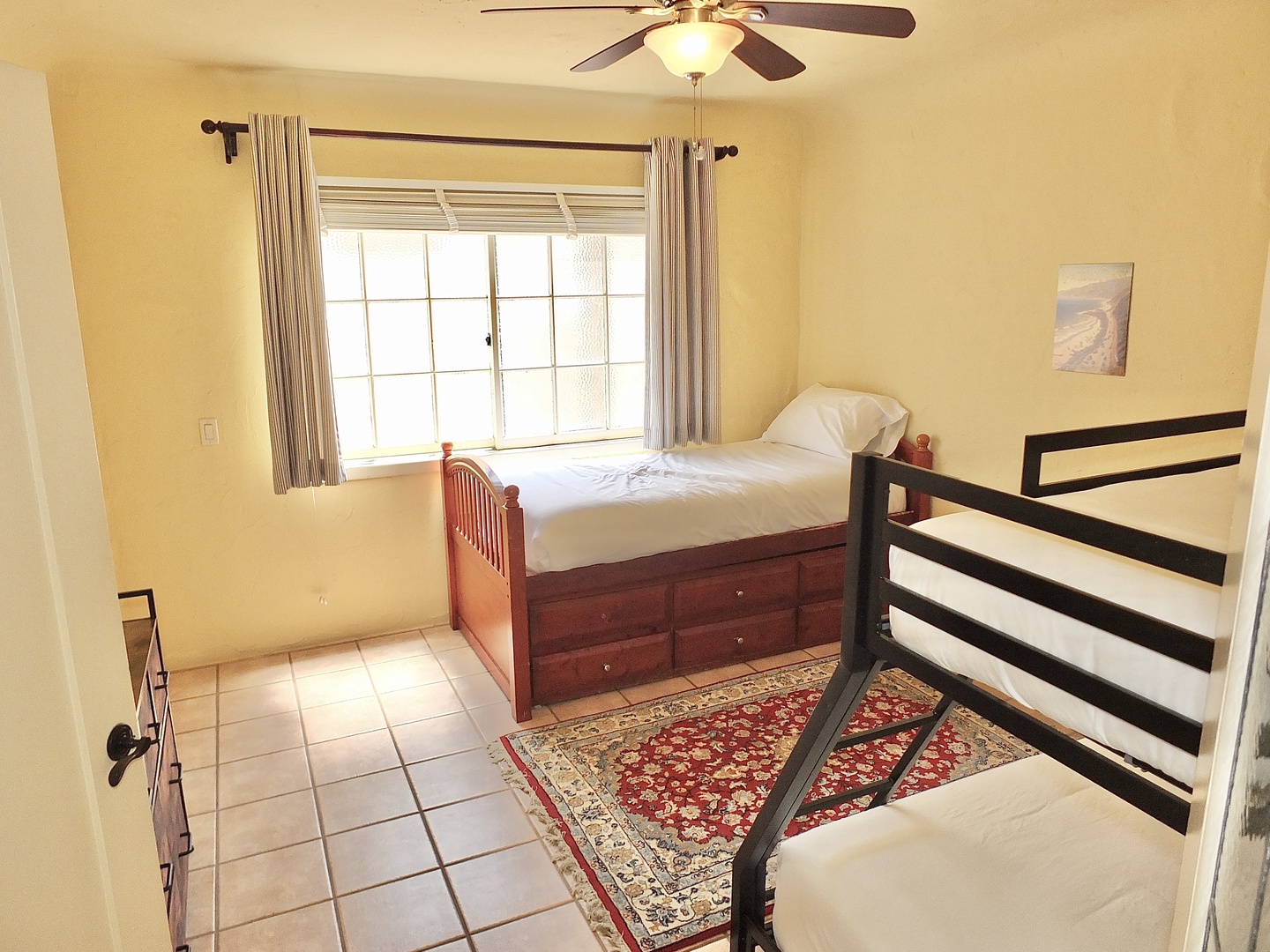 The 1st floor bunk room offers a twin bed and twin-over-full bunkbed with a private En Suite
