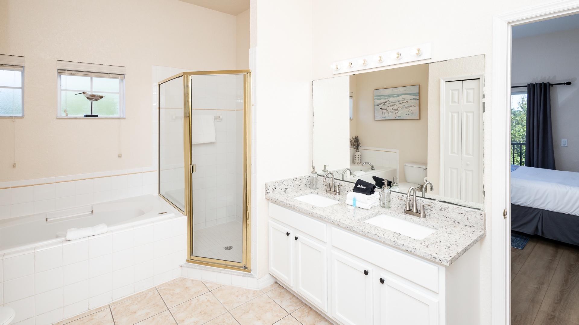 A double vanity, glass shower, & soaking tub await in the second full bath