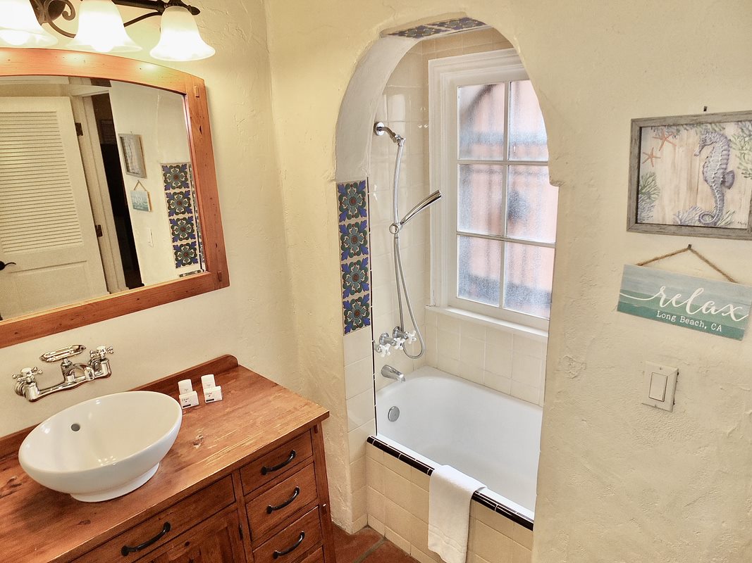 The 1st floor en suite offers a stylish basin vanity and shower/tub combo