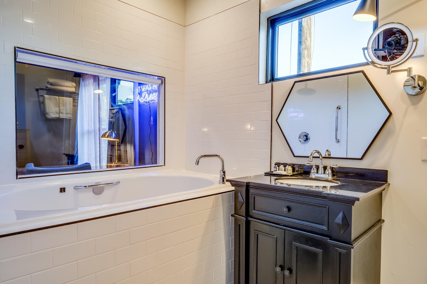 Suite 203 – The 2nd Floor Blue Mid-Century En Suite boasts a Single Vanity with makeup mirror & deep Soaking Tub with Shower