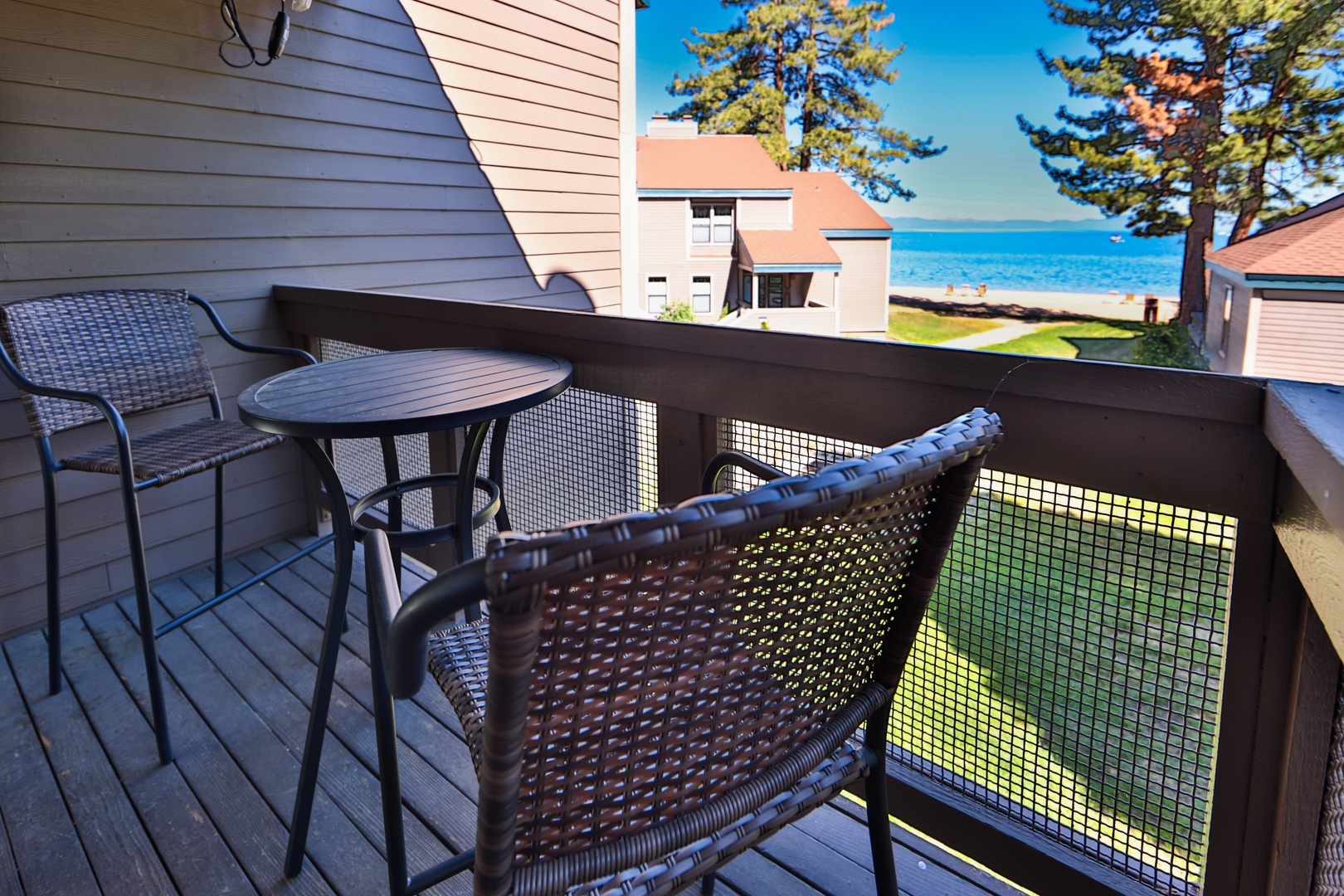 Private balcony with outdoor seating and lake view