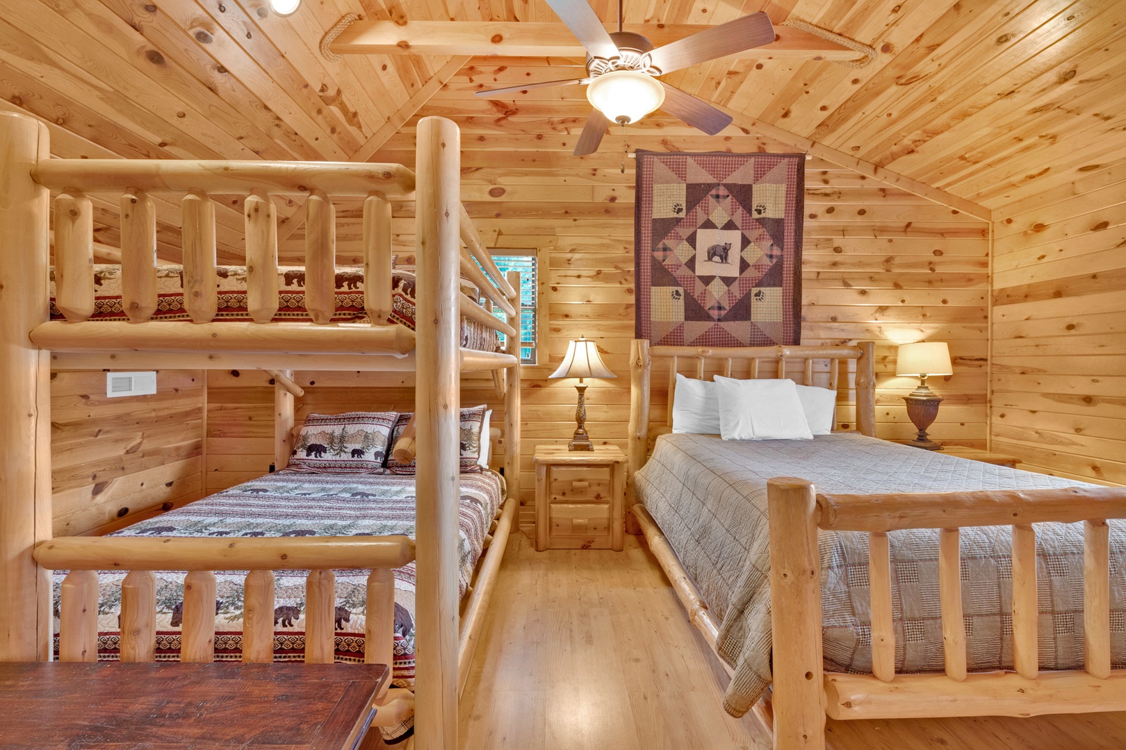 The second-floor bunk room offers a Smart TV, 1 queen bed & queen-over-queen bunks