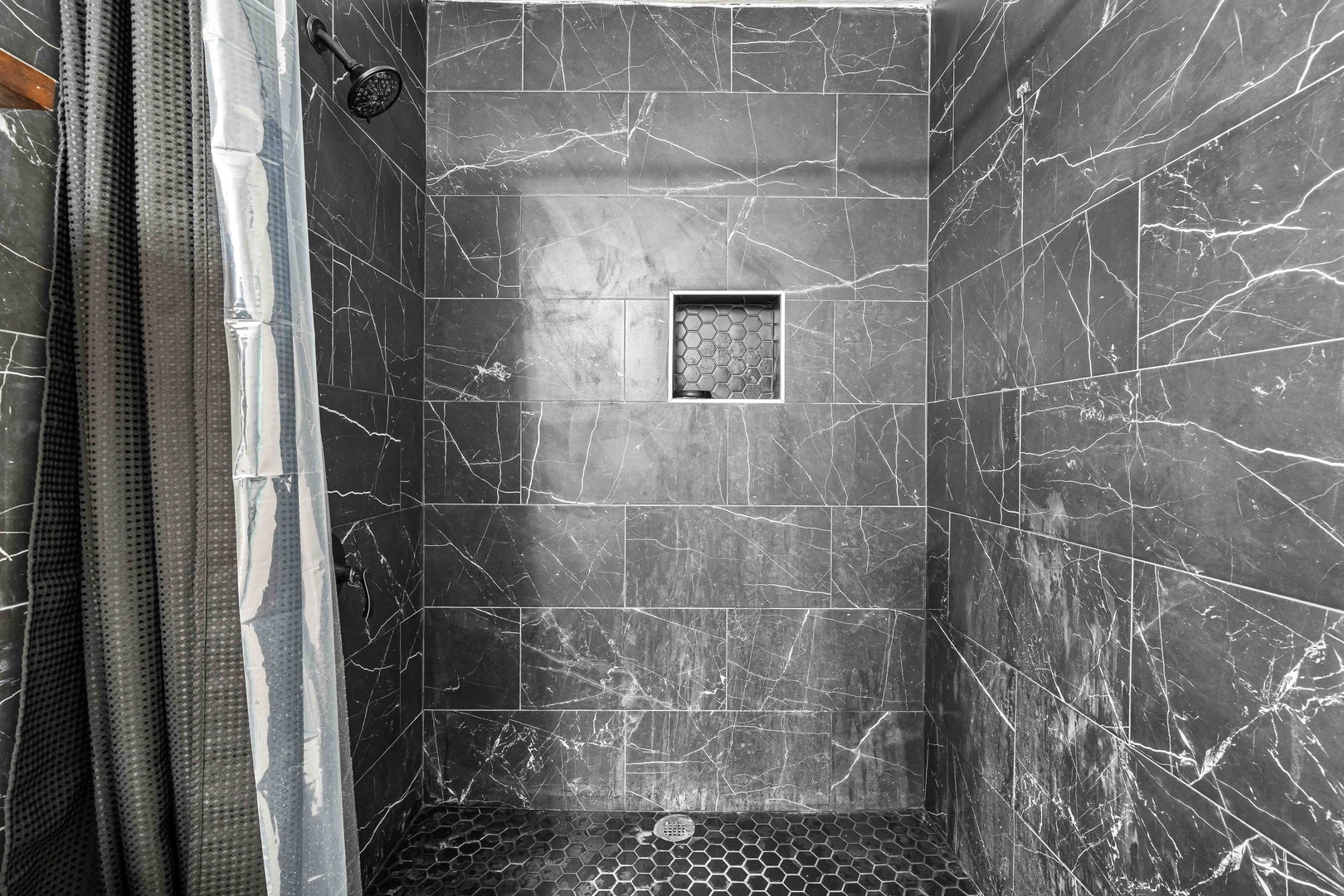 A single vanity, walk-in shower await in the ensuite bath