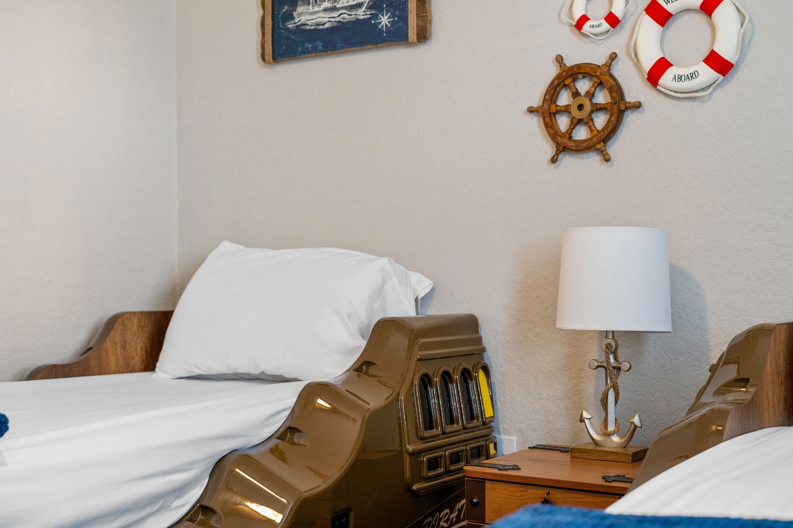 This 2nd floor bedroom offers a pair of nautical twin beds & TV